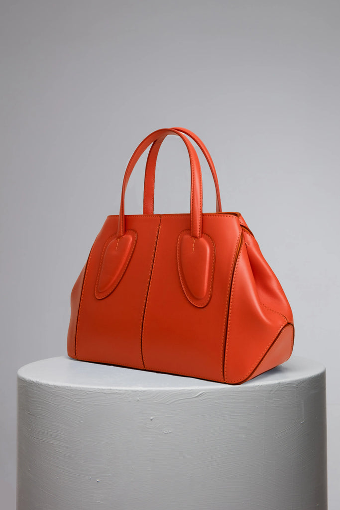 medium orange calf leather woman handbag on grey stand