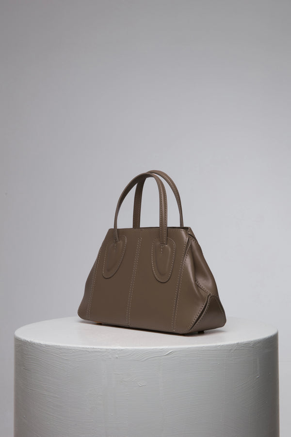 brown leather handbag with two strap on white stant