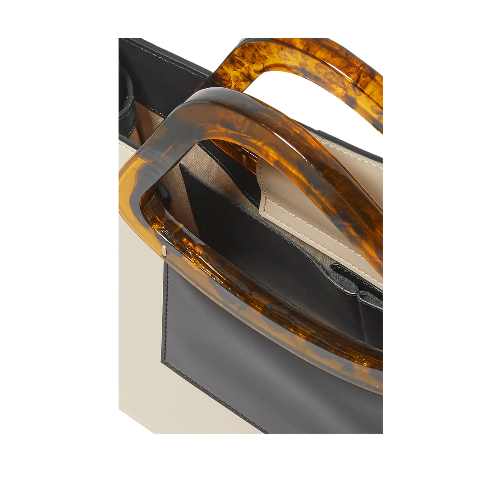 Beige black calf leather medium structured rectangle bag with bio resin handle and removable calf leather shoulder strap on a white stand