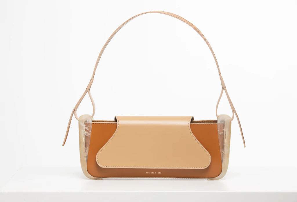 Oyster calf leather rectangle baguette bag with special resin cover companents on the sides. non-removable shoulder strap on a white stand