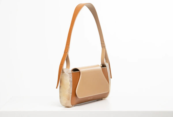 Oyster calf leather rectangle baguette bag with special resin cover companents on the sides. non-removable shoulder strap on a white stand