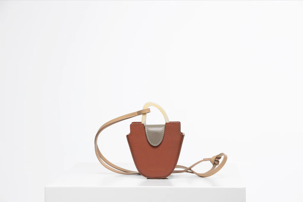 Mini flat topped oval structured retro brown calf leather tote bag with natural resin round handles and a removable adjustable calf leather strap.