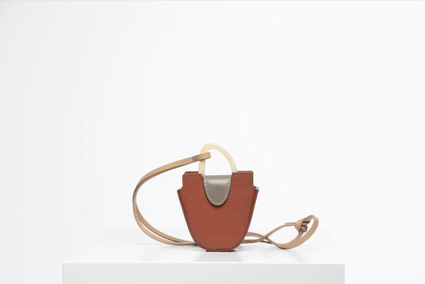 Mini flat topped oval structured retro brown calf leather tote bag with natural resin round handles and a removable adjustable calf leather strap.