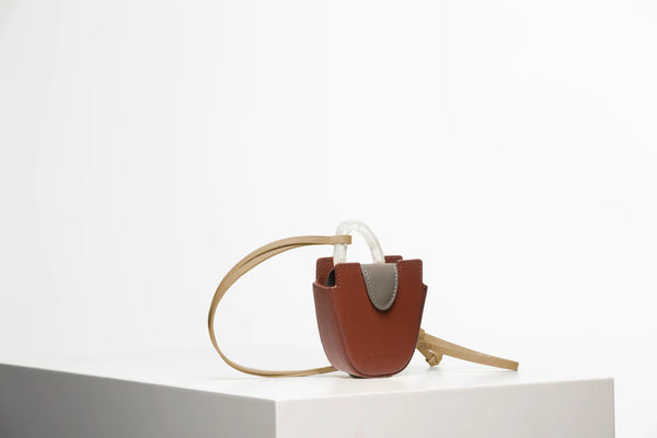 Mini flat topped oval structured retro brown calf leather tote bag with natural resin round handles and a removable adjustable calf leather strap.